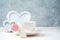 Coffee Cup on a saucer, white frame, hearts on a white-gray background.
