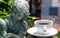Coffee cup and Sculpture of angel