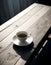 A coffee cup with singleorigin coffee rests on a saucer on a table