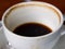 Coffee cup stained, americano coffee drink left over on wooden table background, Close up and macro shot, Selective focus