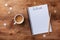 Coffee cup, stars confetti and notebook with to do list on wooden desk top view, planning and design concept