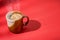 Coffee cup with steam on red