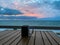 A coffee cup on a table with a vibrant sunrise over the Atlantic Ocean on North Hutchinson Island in Florida