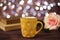 Coffee cup, tea, old books and rose on wood table in cafe with bokeh light background. Leisure lifestyle concept.