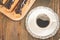 Coffee cup, teapot and eclairs/coffee cup, teapot and eclairs on a wooden background. Top view