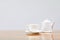 coffee cup and teapot white On the glass table wooden and a cement wall background