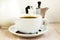 Coffee cup white, saucer and beans, aluminum coffee maker, jag. Breakfast concept