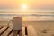 Coffee cup on wood table at sunset or sunrise beach