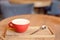 Coffee cup on wooden tray in modern cafe interior with blurred background.