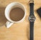 Coffee cup and wrist watch