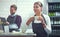 This coffee is definitely going on the menu. a young woman having coffee in her store while her coworker uses a digital