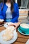 Coffee Delights: Young Unrecognizable Women drinking Coffee and eating Sweet Pastries in a Cozy Cafe Patio