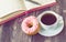 Coffee, donut and notepad on wooden background