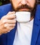 Coffee drink. Bearded man, hands holding a hot coffe cups. Beard man hold coffee or coffe cup at cafe in the morning