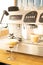 Coffee drinks near professional coffee machine on restaurant bar counter