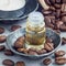 Coffee essential oil in glass bottle on background with coffee beans, square format