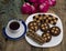 Coffee, fir-tree branch, roses and a plate with baking