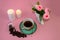 .coffee, flowers, candles on a pink background as a symbol of home warmth and coziness, beauty and a wonderful morning breakfast