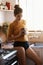 Coffee-fuelled morning thoughts. A young woman casually drinking coffee while standing in her kitchen.