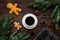 Coffee with gingebread cookies in christmas evening. Cup near spruce branch on dark wooden background top view