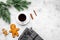 Coffee with gingebread cookies in christmas evening. Cup near spruce branch on grey wooden background top view copyspace