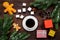 Coffee with gingebread cookies and gifts in christmas evening. Dark wooden background top view