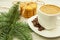 Coffee and ginger biscuits with spruce branches on a wooden background, hearty and healthy breakfast