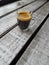 coffee in a glass cup on a wooden cafe table
