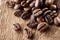 Coffee grains over wooden table