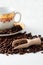 Coffee grains, wooden spoon and white cup