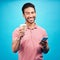 Coffee, happiness and portrait of man with phone in studio isolated on a blue background. Tea, cellphone and smile of