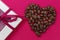 Coffee heart, roasted coffee beans and chocolate. Concept of Valentine`s Day, good mood, Endorphins, greeting cards