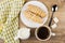 Coffee, jug milk, eclairs in plate, napkin, sugar and spoon