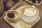 Coffee latte art served on wood plate decorated in cafe