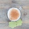 Coffee latte in glass cup with matcha cookies, top view, square format