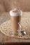 Coffee latte macchiato with cream in glass