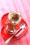 Coffee latte on red heart plate