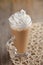 Coffee Latte with whipped cream in rustic style