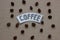 Coffee lettering with grains of coffee on a cardboard backgroun