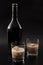 Coffee liqueur and alcoholic beverages based on milk and whiskey concept with Irish cream bottle and glasses with ice isolated on