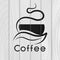 Coffee logotype. Stylized coffee cup icon on wooden background. Vector