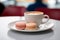 Coffee and macarons on cafe table.