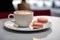 Coffee and macarons on cafe table.