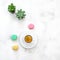 Coffee macarons cookies succulent plants table flat lay