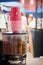 Coffee machine with grains and paper glasses is standing outside waiting for customers