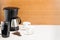 Coffee machine with pot and handful coffee beans on the wood and marble background. Copy space