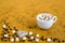 Coffee with marsh-mallows on yellow background