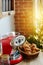 Coffee mashine with croissant, fir branches and Christmas decorations on wooden table in the kitchen. Cozy homely scene