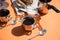 Coffee in metal cups, milk, rolls, orange background, sun glare and shadows-summer Breakfast.
