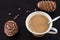 Coffee or milk tea chai with pine nuts cedar vegan milk. Black wooden background and cones of Siberian cedar pine. Top view.